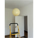 Cream pendant light installed in a hallway – the soft yellow swirl BO-HA Kaja glass globe on its cord.