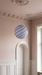 Globe pendant light on a landing with blush pink walls and a ceiling rose, the blue BO-HA Kaja.