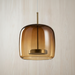 Caramel glass bell shade on a clear cable, shown against pale whitewashed wood, BO-HA Astrid